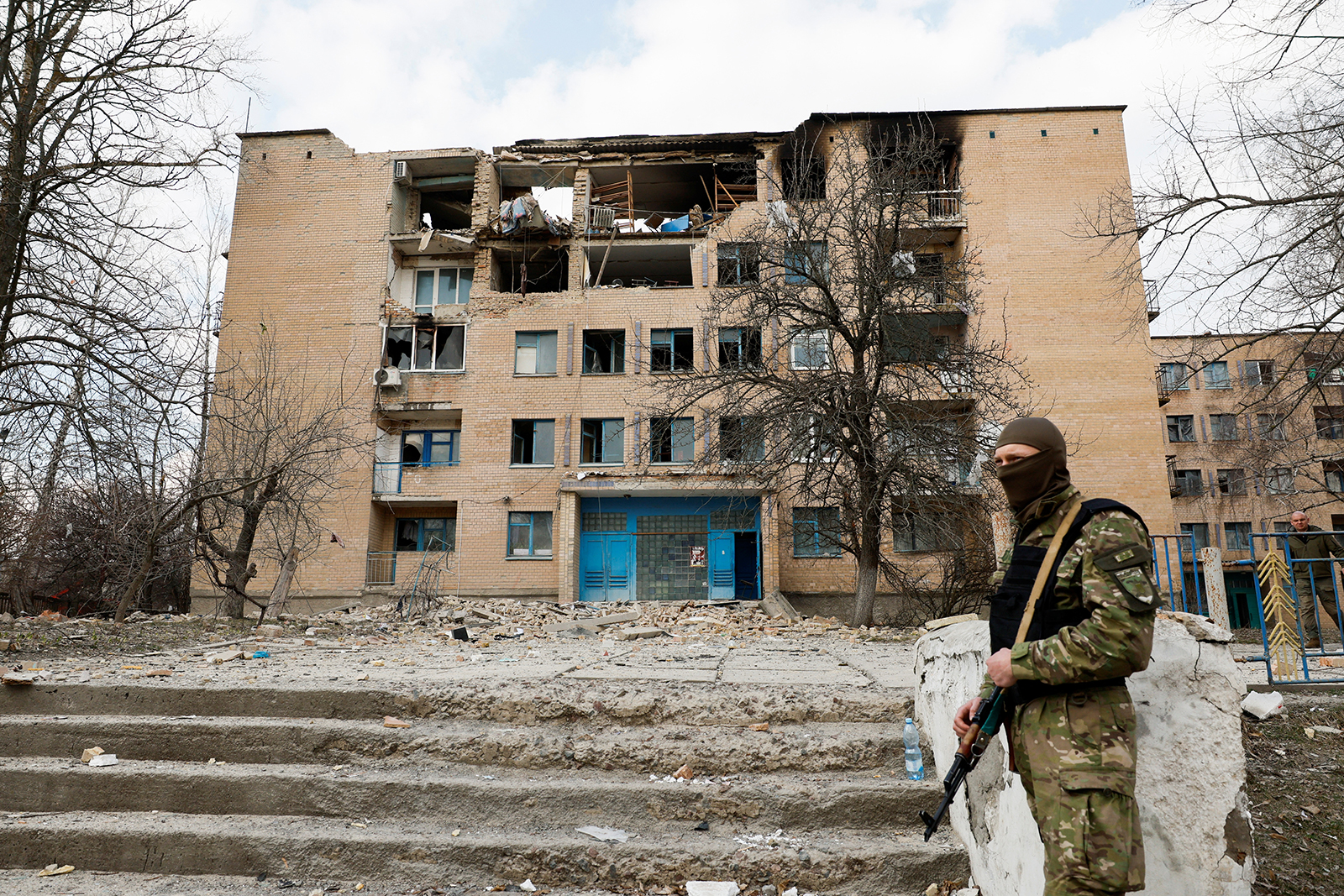 A security personnel stands guard at a site of a building heavily damaged by Russian drone strikes in Kyiv region, on March 22.