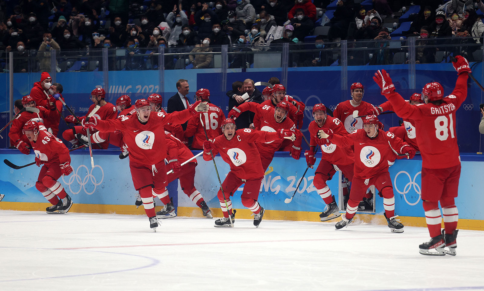 The Russian Olympic Committee hockey team celebrates after defeating Sweden in a penalty shootout on February 18.