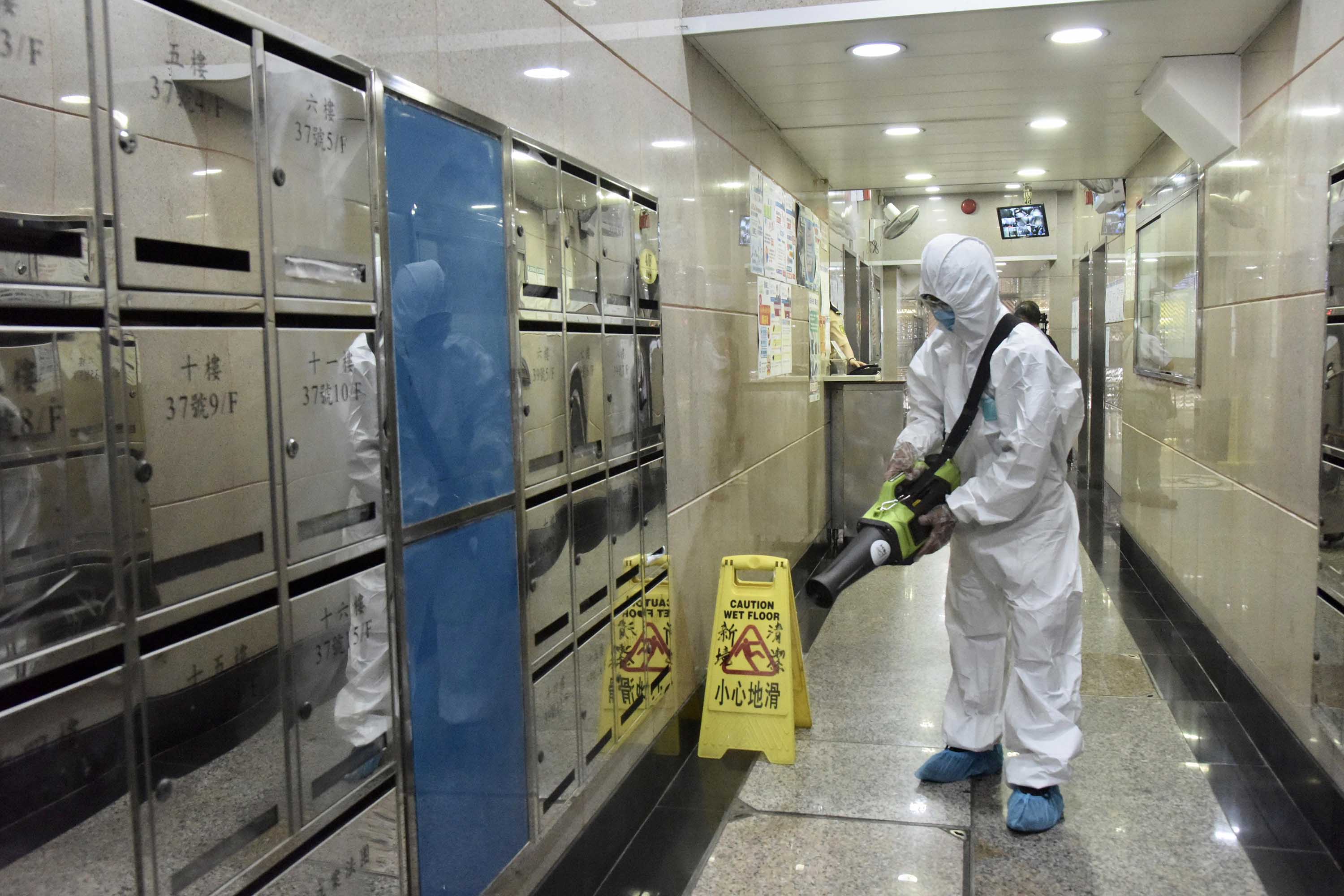 A worker sprays disinfectant at a residential block in Hong Kong on July 8.