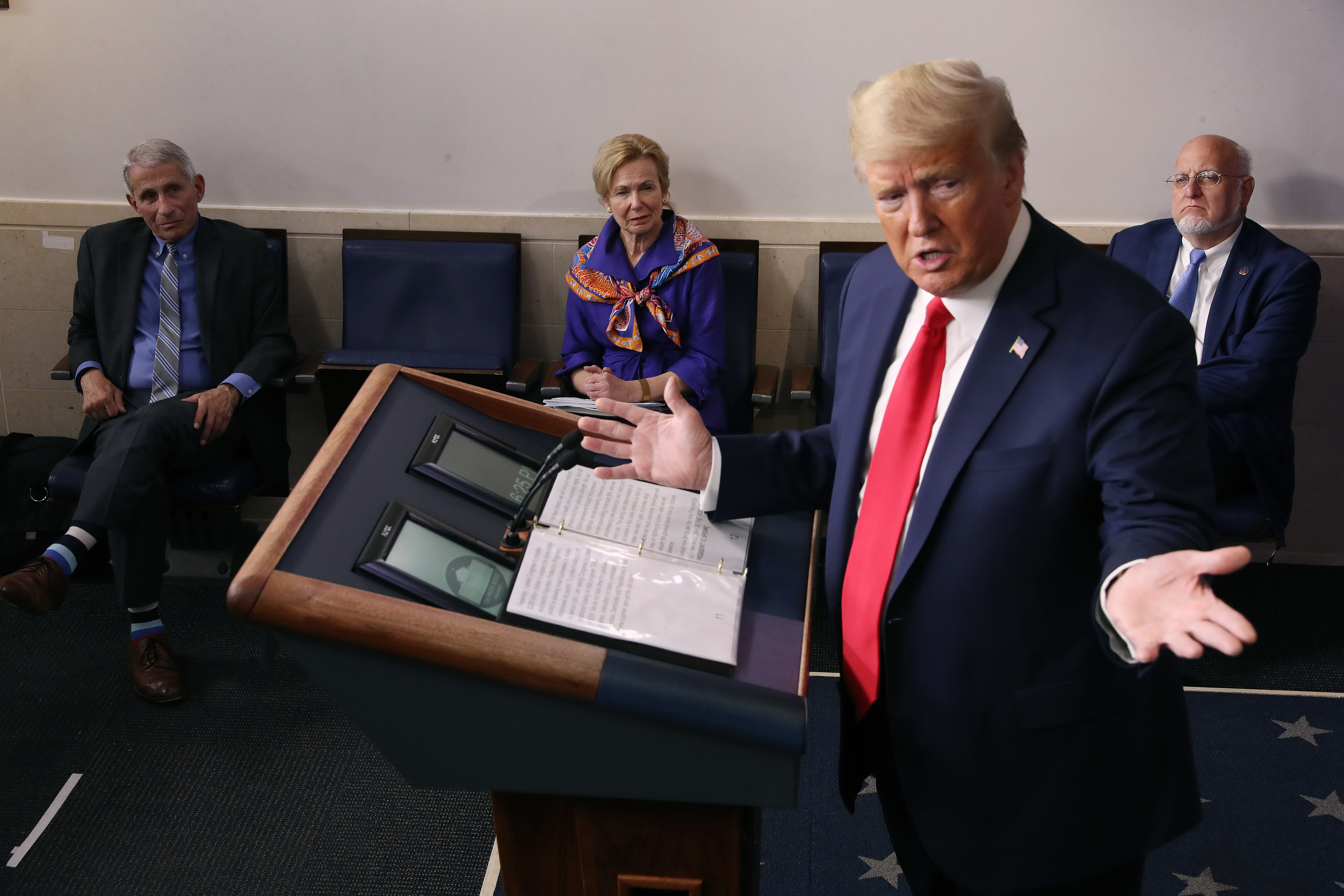 President Donald Trump speaks during a coronavirus task force briefing at the White House on April 8. In the background are, from left, Dr. Anthony Fauci, director of the National Institute of Allergy and Infectious Diseases; Dr. Deborah Birx, White House coronavirus response coordinator; and Dr. Robert Redfield, director of the Centers for Disease Control and Prevention.