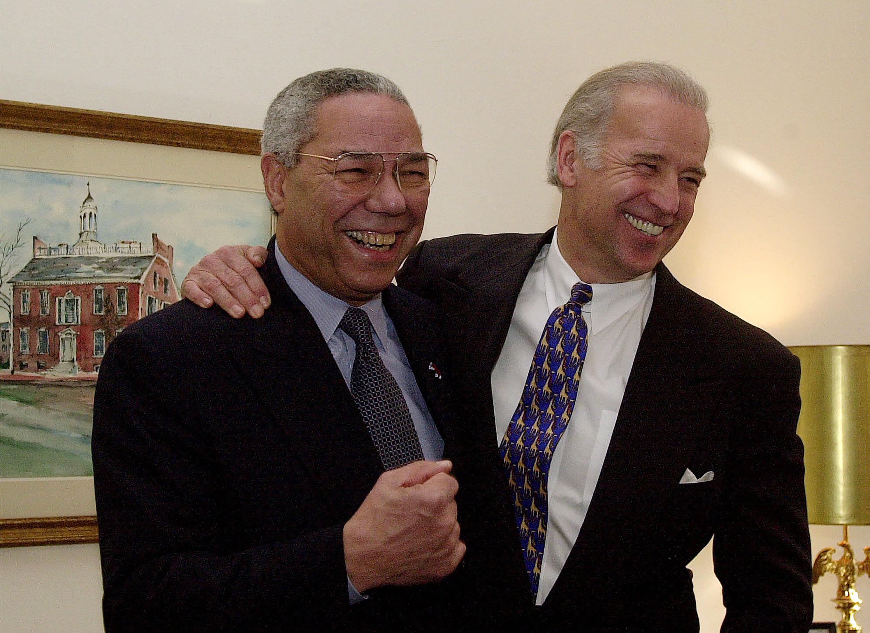 Then-Secretary of State-designate Colin Powell, left, and then-Sen. Joe Biden, pose for photographers on Capitol Hill in January 2001.