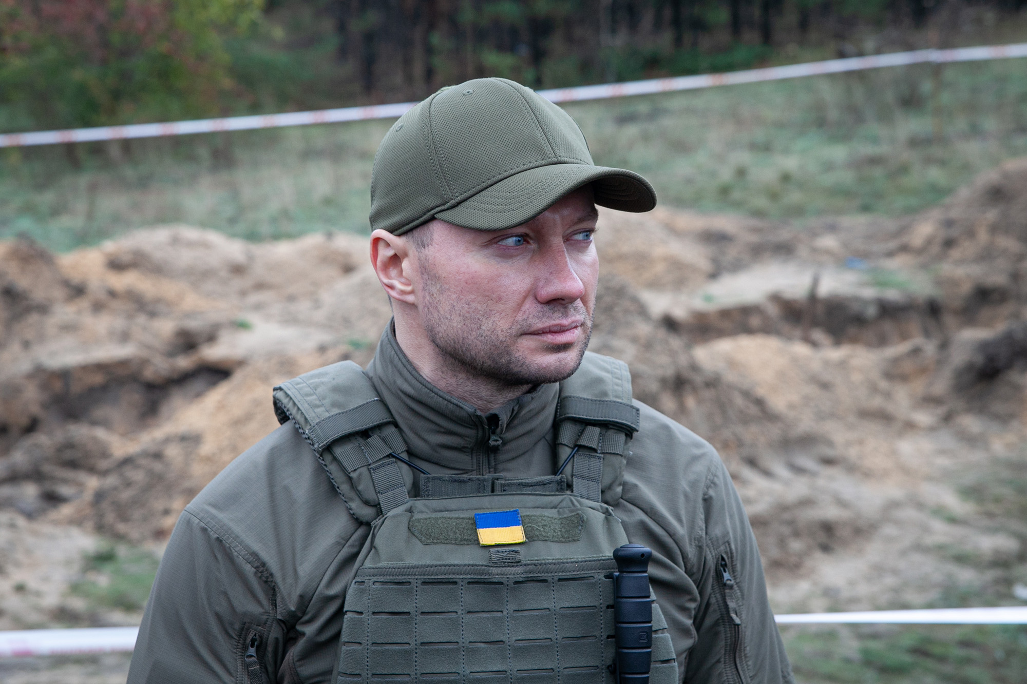 Pavlo Kyrylenko, the Head of the Donetsk Regional Military Administration, stands at the site of a mass burial on October 11, in Lyman, Ukraine. 