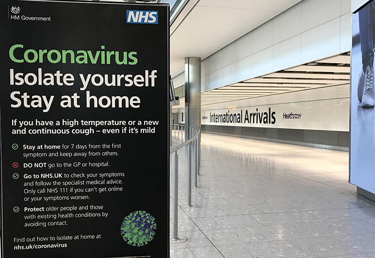 A sign at Heathrow Airport Terminal 5 arrivals warns of coronavirus, in London, Tuesday, March 24.
