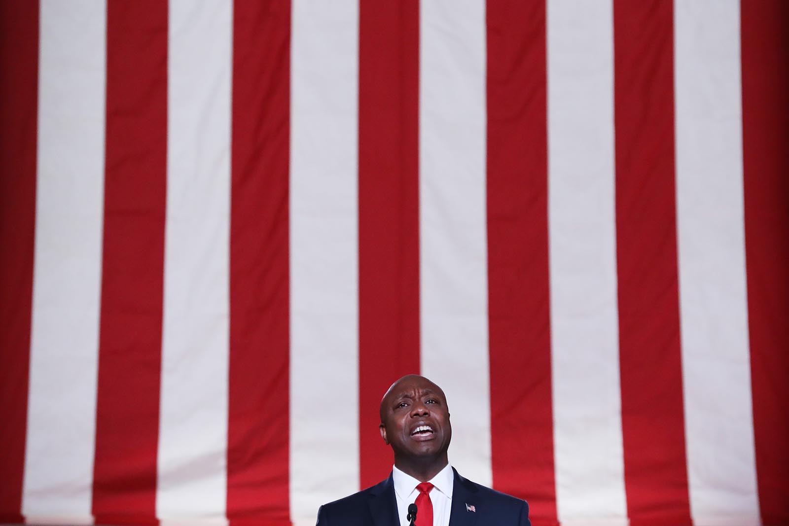 Sen. Tim Scott of South Carolina stands on stage in an empty Mellon Auditorium while addressing the Republican National Convention on Monday in Washington.