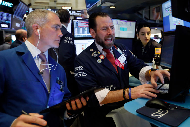 Trader Timothy Nick, left, and specialist Michael Pistillo work on the floor of the New York Stock Exchange, Tuesday, March 3.