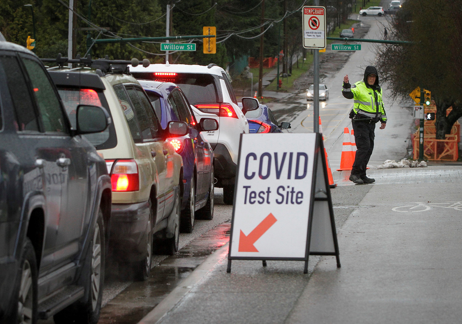 A police officer directs the traffic outside a Covid-19 test site in Vancouver, British Columbia, Canada, on Dec. 18.