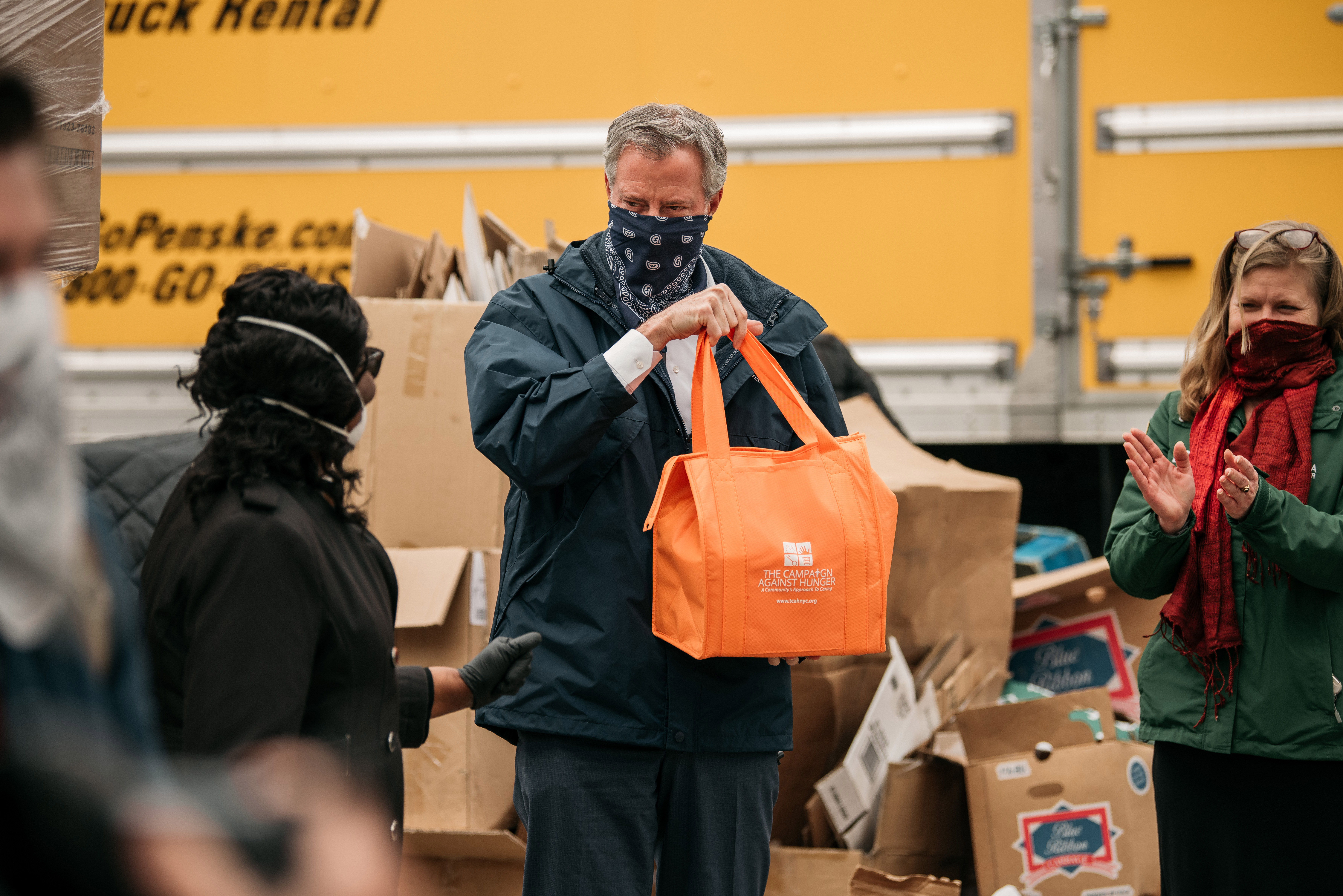 New York City Mayor Bill de Blasio holds a bag of produce packed at a food shelf organized by The Campaign Against Hunger in Bed Stuy, Brooklyn, on April 14.
