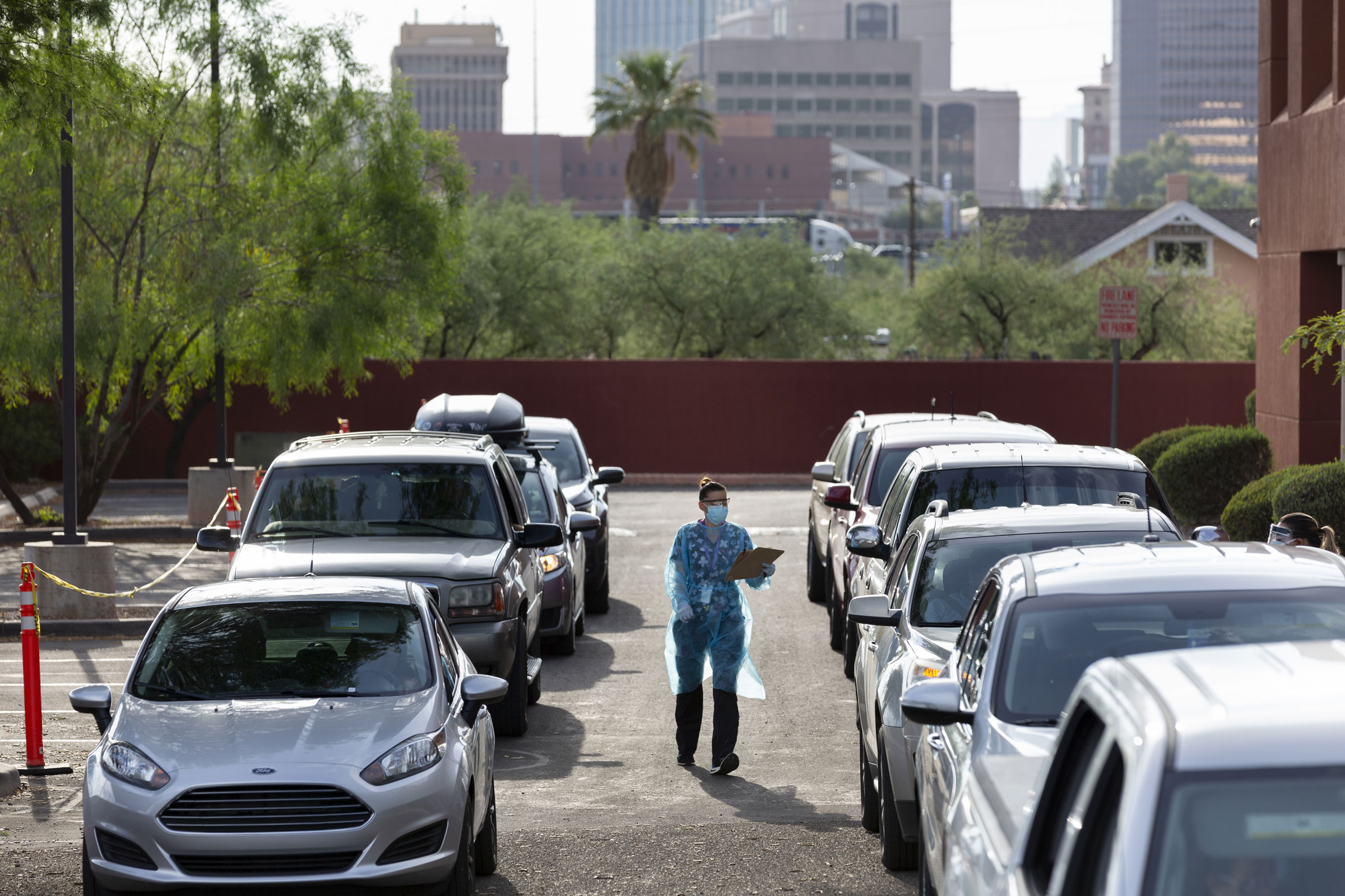 A health-care worker collects paperwork at a drive-thru testing site in Tucson, Arizona, on Monday.