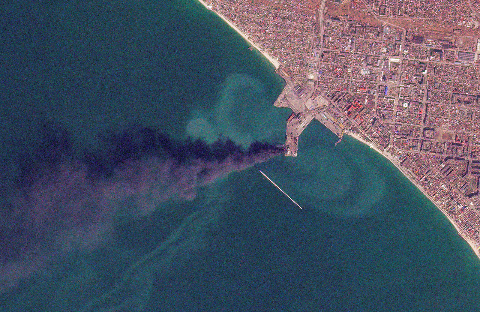 In this satellite photo smoke rises after an attack that Ukraine's navy said sank a large Russian landing ship in the port city of Berdyansk, Ukraine, on March 24.