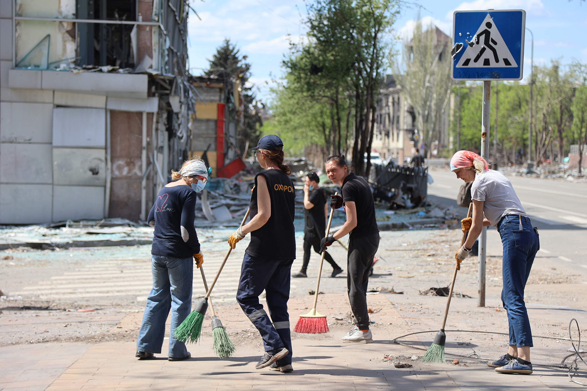 Municipality workers clean streets in Mariupol, Ukraine on April 27, 2022. 