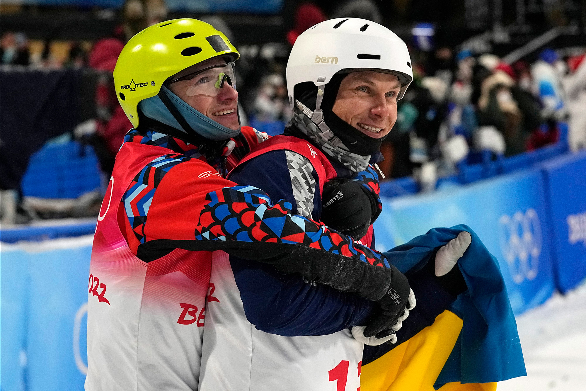 Russian freestyle skier Ilia Burov hugs Ukraine's Oleksandr Abramenko as they celebrate medaling in the aerials final on Wednesday.