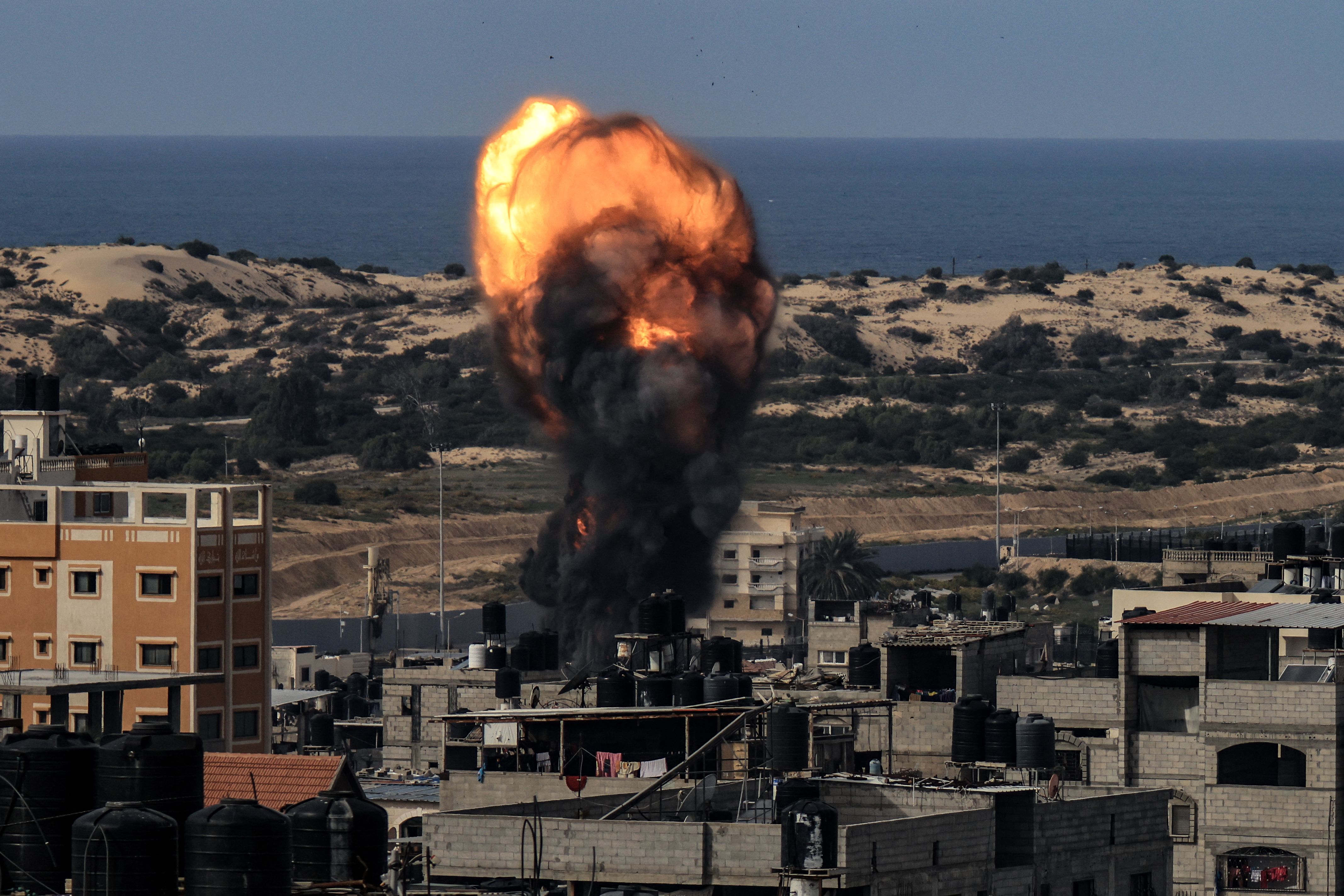 A ball of fire rises above a building during an Israeli strike in Rafah, southern Gaza, on December 9.