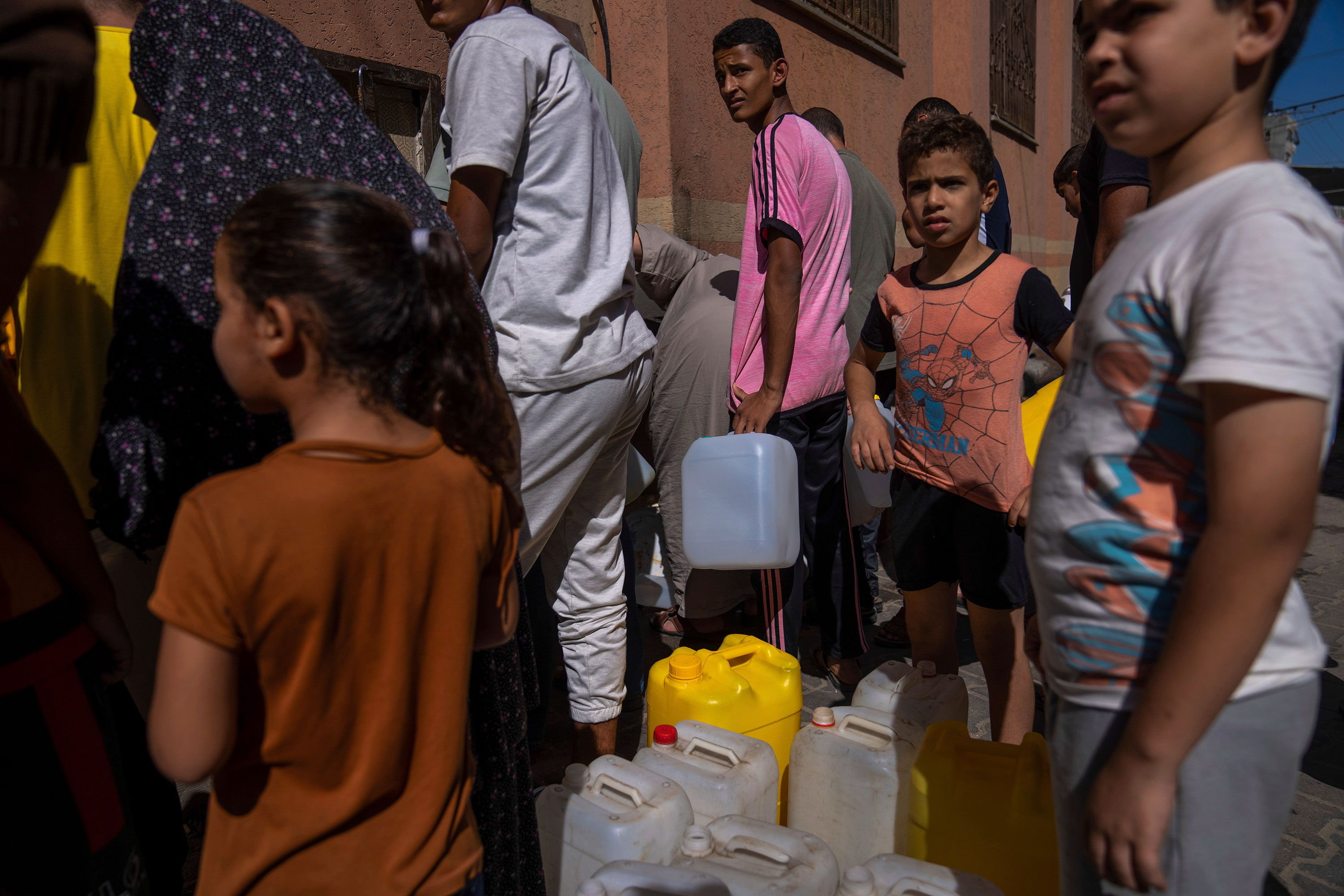 Palestinians collect water from a tap in Khan Younis, Gaza, on Sunday, October 15. 