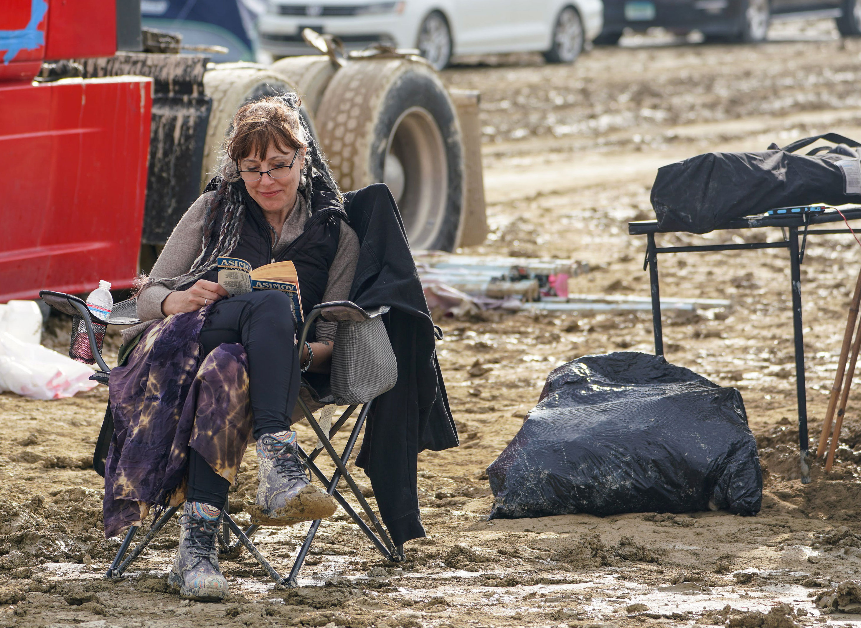Barbara Wahl reads a book to pass time while waiting to leave Burning Man on Sunday, September 3. 