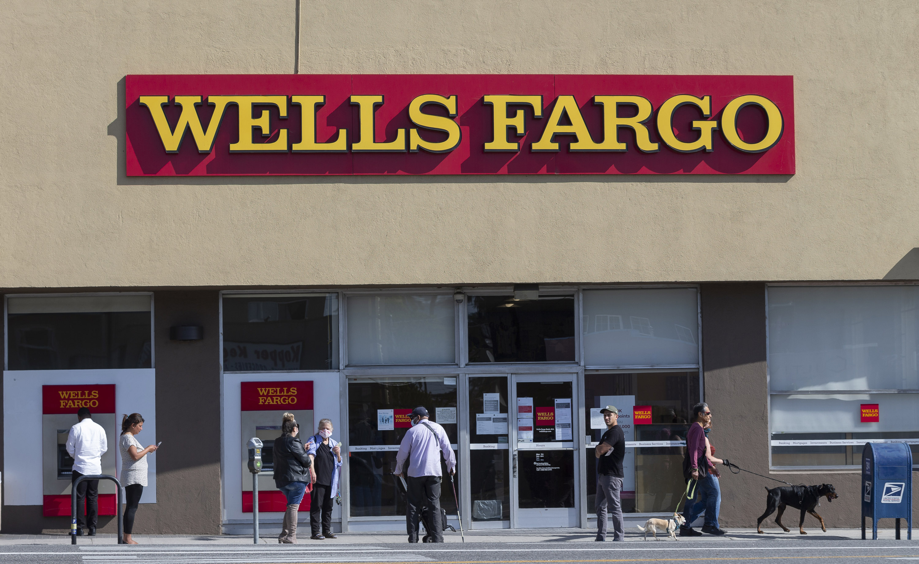 People stand outside a Wells Fargo branch in the Atwater Village neighborhood in Los Angeles on April 3.