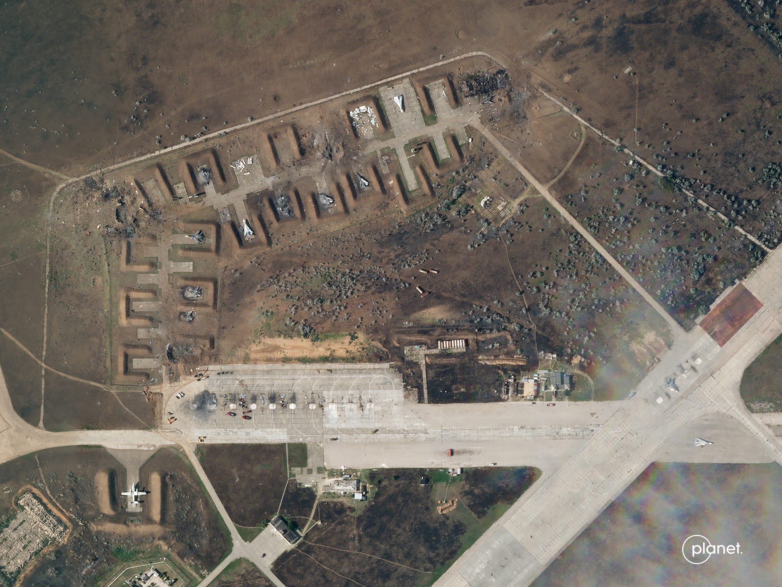 A satellite image from August 10 shows the charred remains of at least seven aircraft after explosions at Saki air base. 
