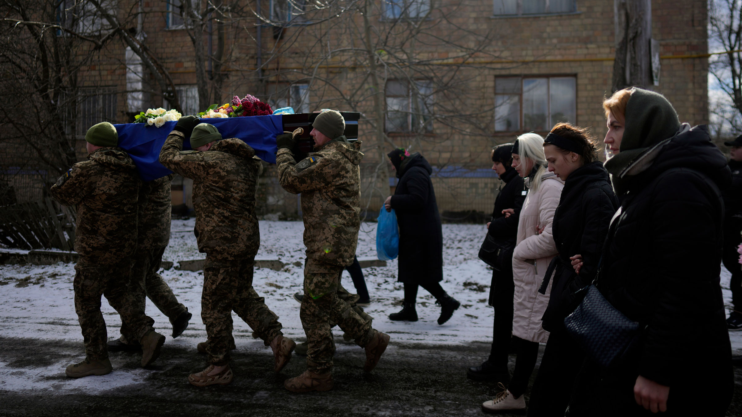 Ukrainian soldiers carry the coffin of paratrooper Vladyslav Bondarenko during his funeral in Kozyntsi, Ukraine, on Monday. Bondarenko, 26, died near Bakhmut on February 26.