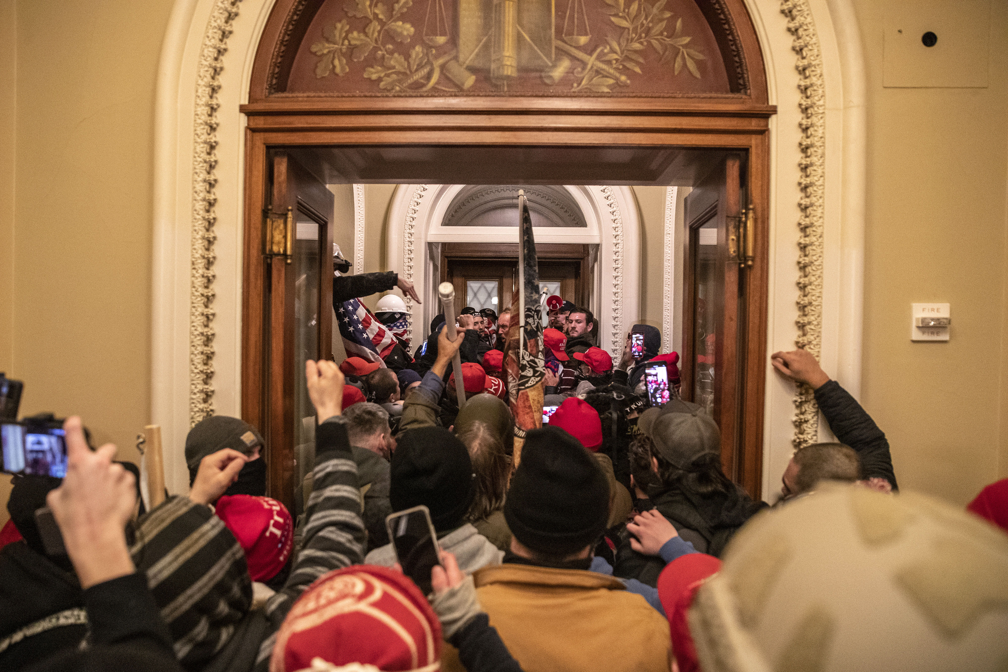Rioters walk through the Capitol after breaching barricades to the building on January 6.