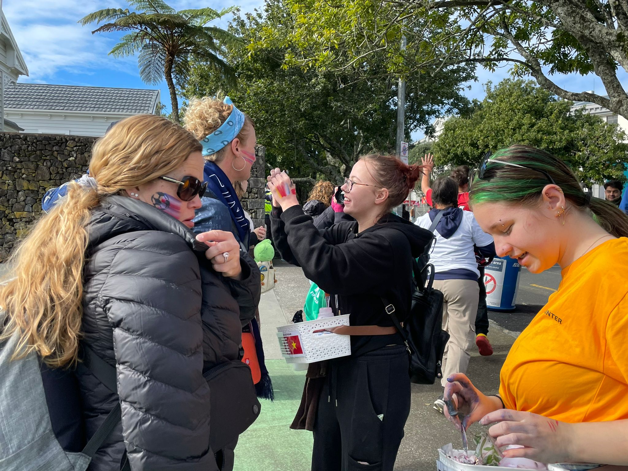 Fans get their faces painted in team colors.