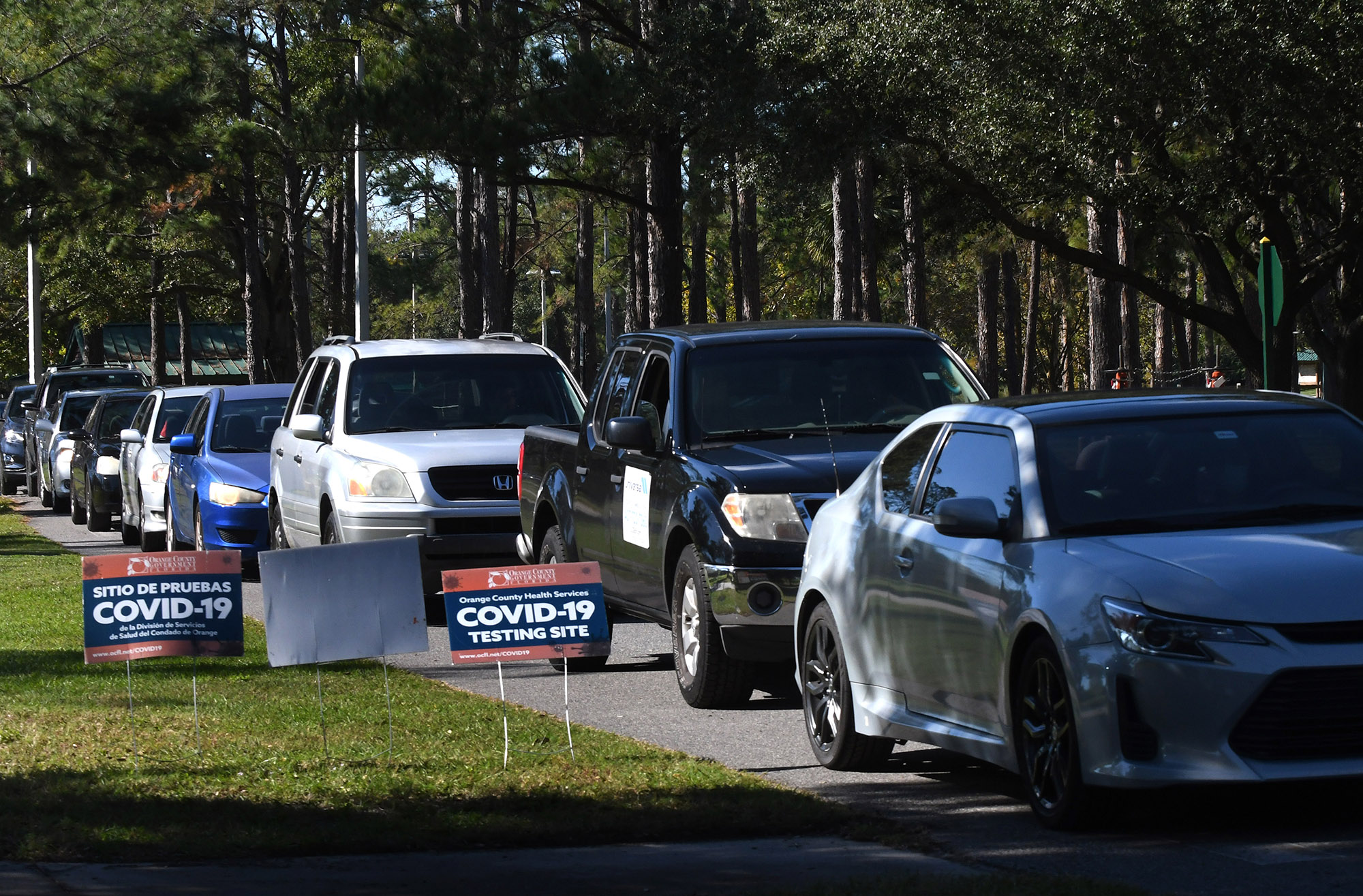 People are seen lined up in their cars at a COVID-19 rapid testing site at Barnett Park in Orlando, Florida on November 23. 