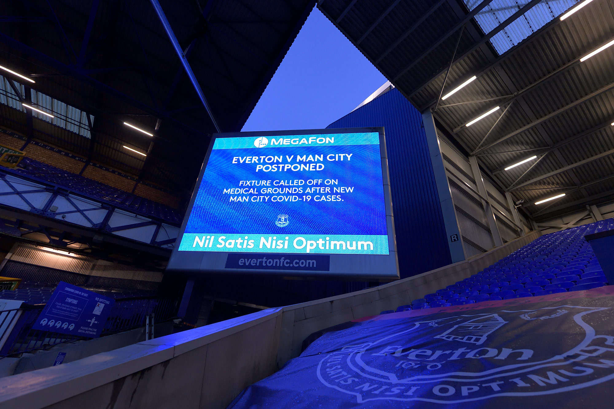 A big screen graphic announces the Premier League match between Everton and Manchester City is postponed at Goodison Park on December 28 in Liverpool, England.