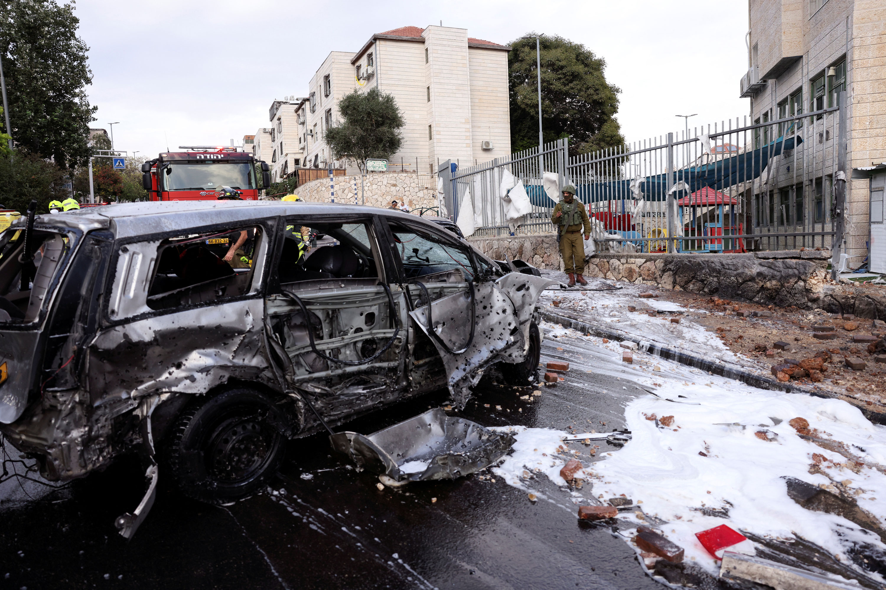 The remains of a destroyed vehicle are seen on a road after a rocket, launched from the Gaza Strip landed in the Israeli settlement of Beitar Ilit, in the Israeli-occupied West Bank on October 9, 2023.