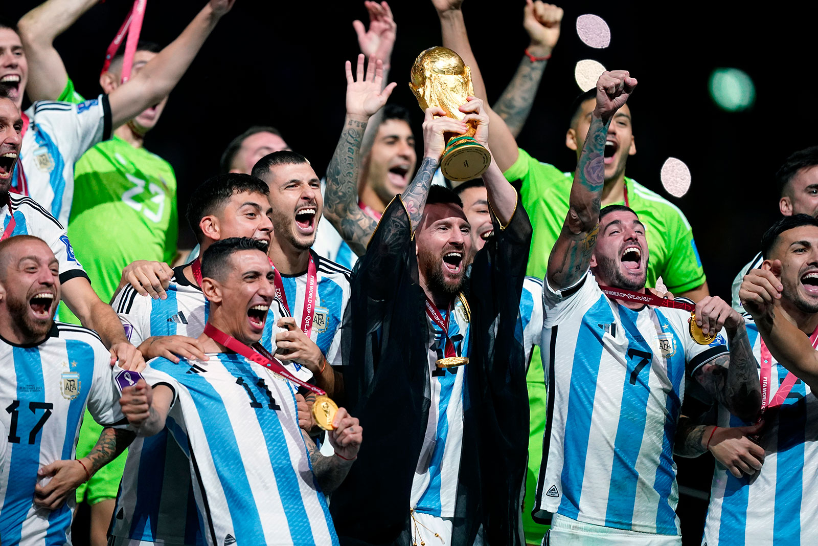 Lionel Messi lifts the FIFA World Cup trophy with his teammates following their victory over France in the final match at Lusail Stadium on Sunday. 