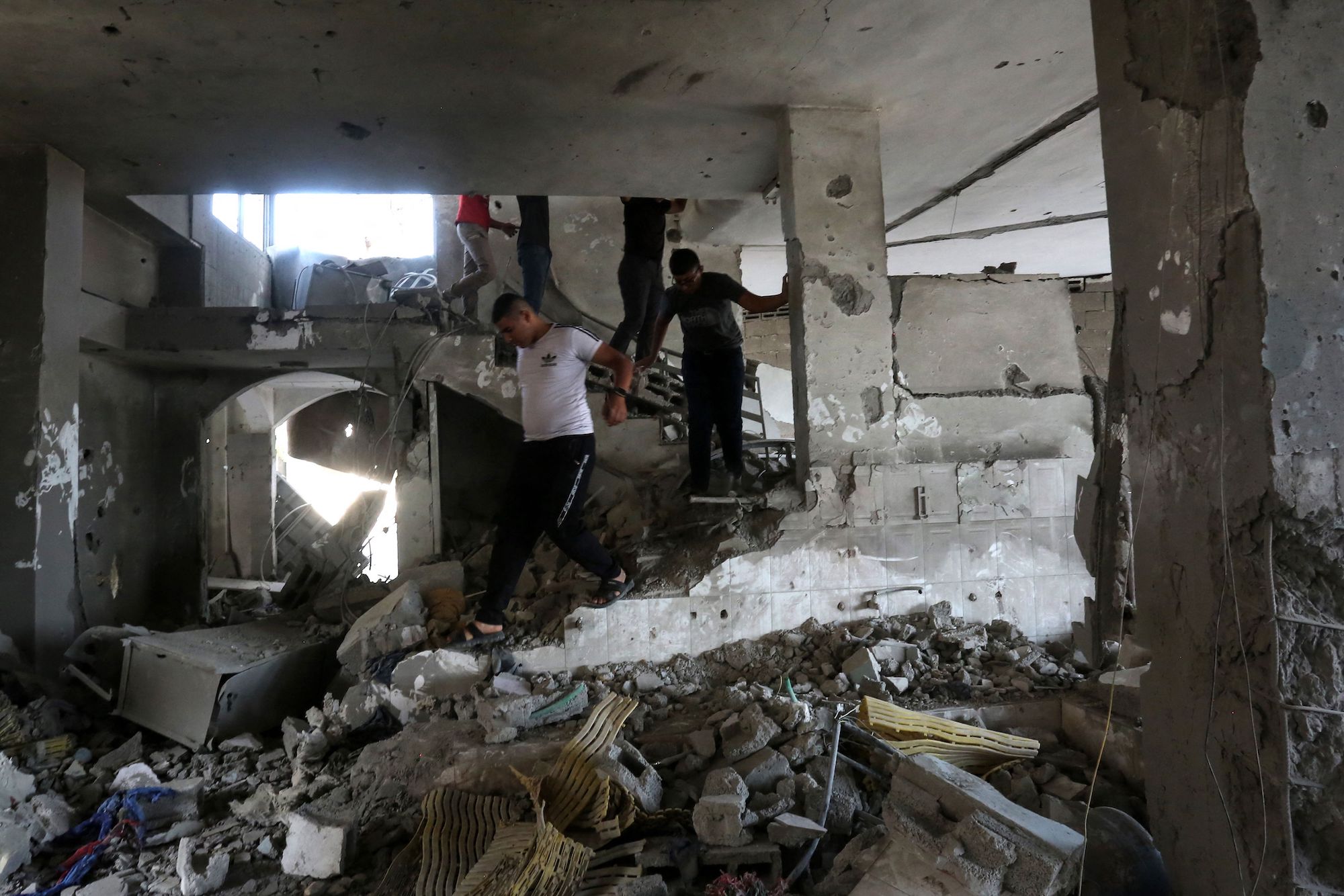People check the damage inside a building in the West Bank city of Jenin, following an Israeli airstrike on Sunday.