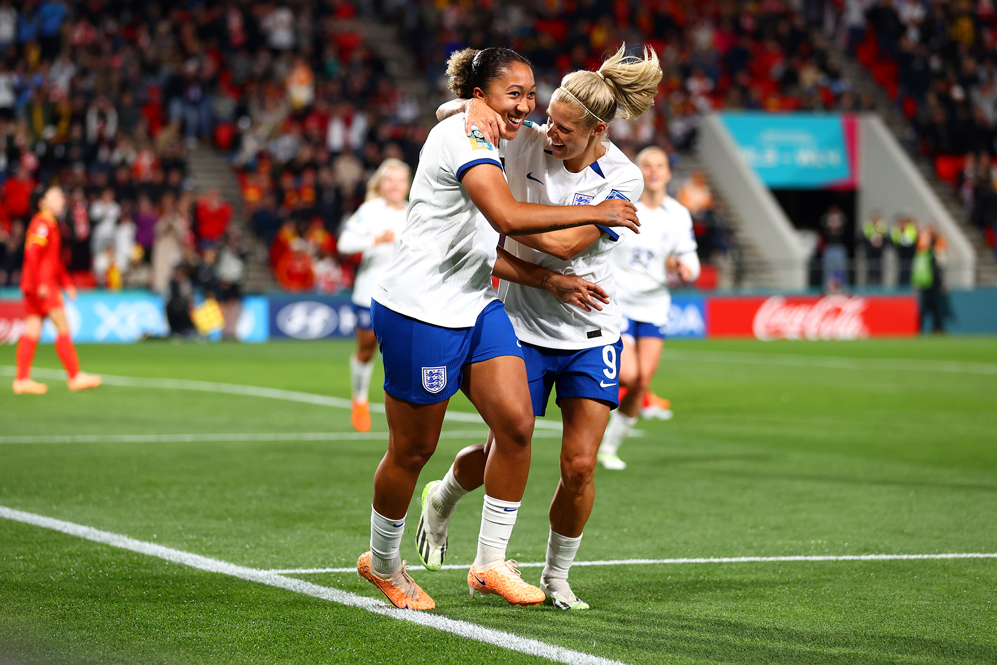 Lauren James of England, left, celebrates with teammate Rachel Daly after scoring her team's fourth goal.