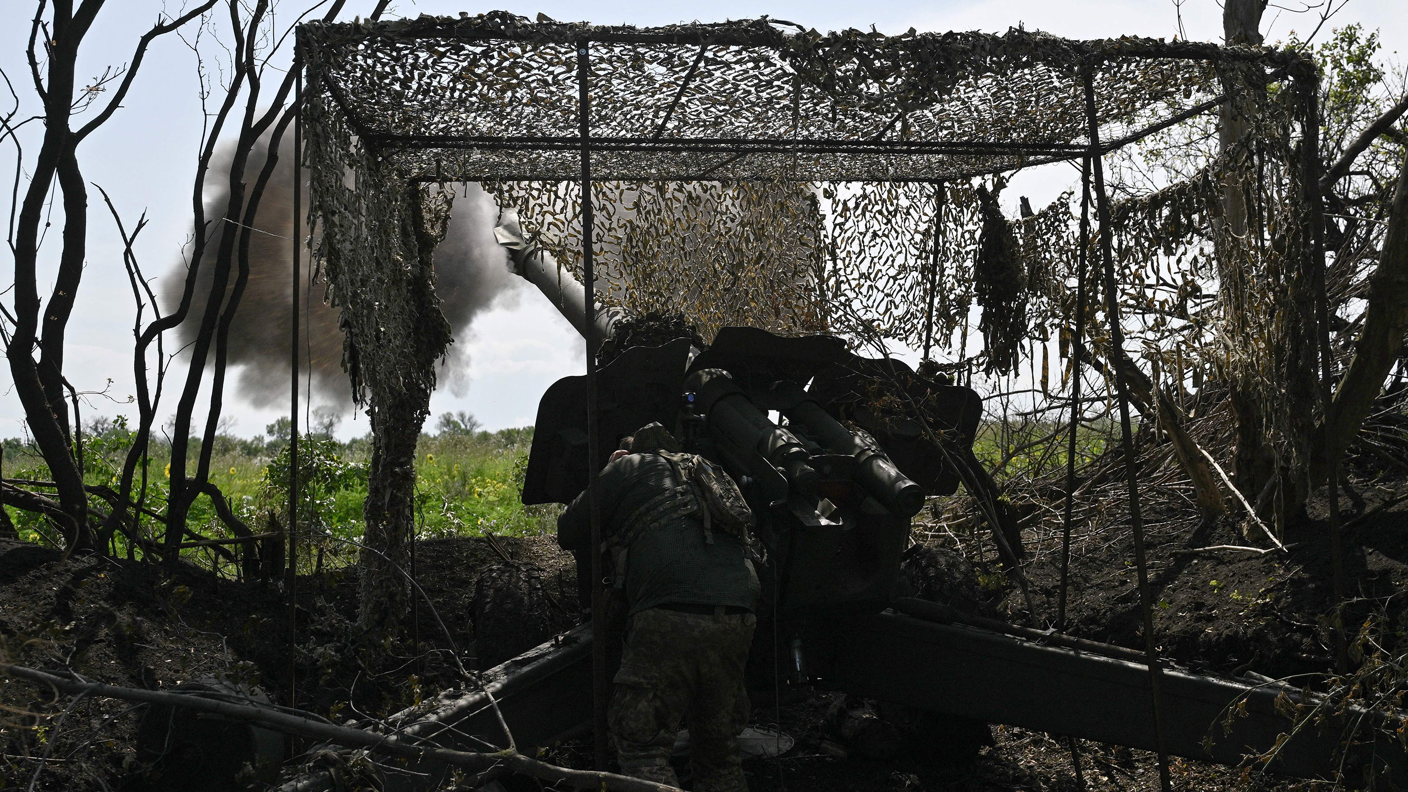 A Ukrainian artilleryman fires a 152mm towed gun-howitzer D-20 at Russian positions on the front line near Bakhmut, eastern Ukraine, on July 20, 2023, amid the Russian invasion of Ukraine.