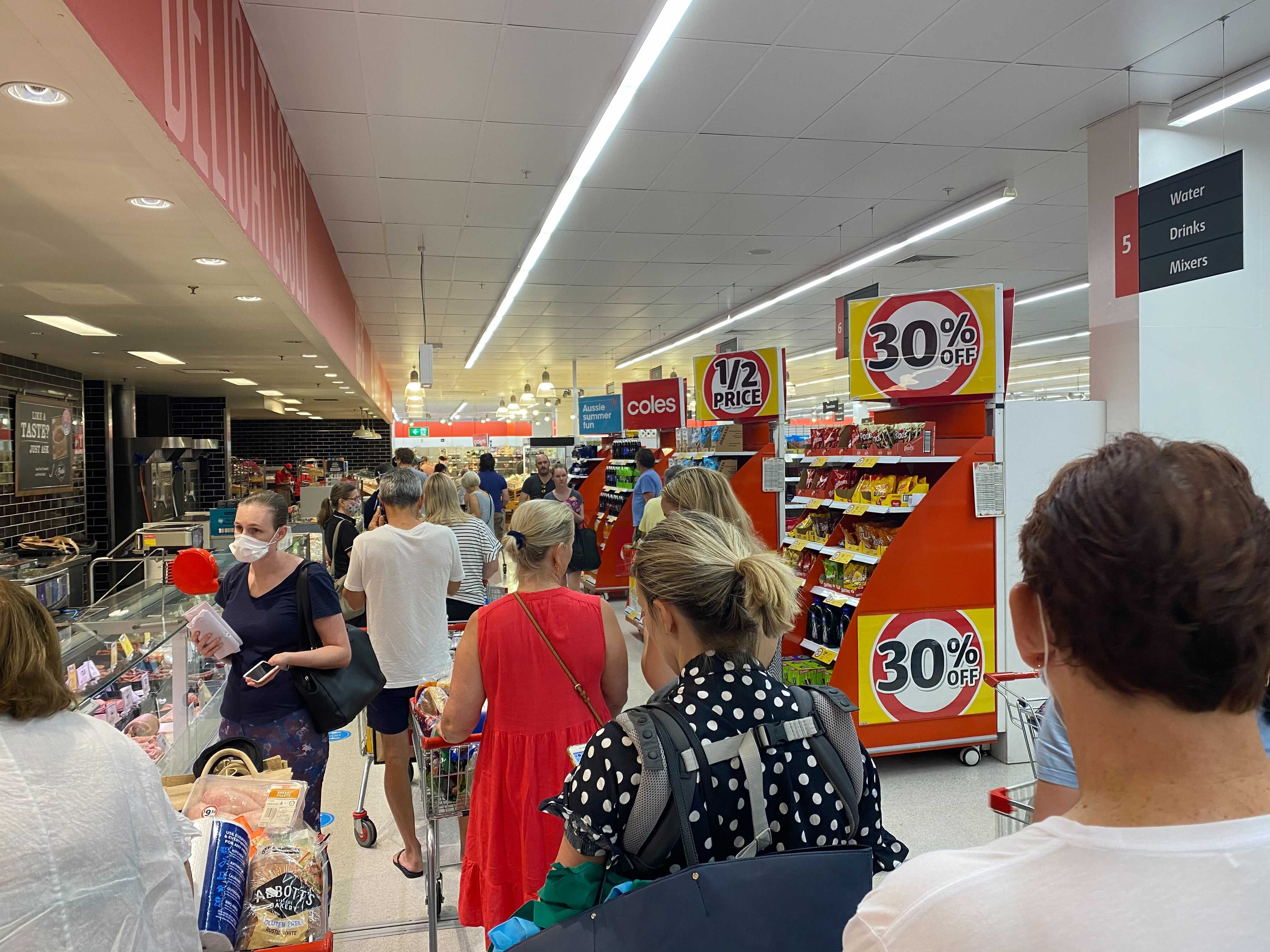 Shoppers in Brisbane rush to buy supplies ahead of a three-day lockdown. 