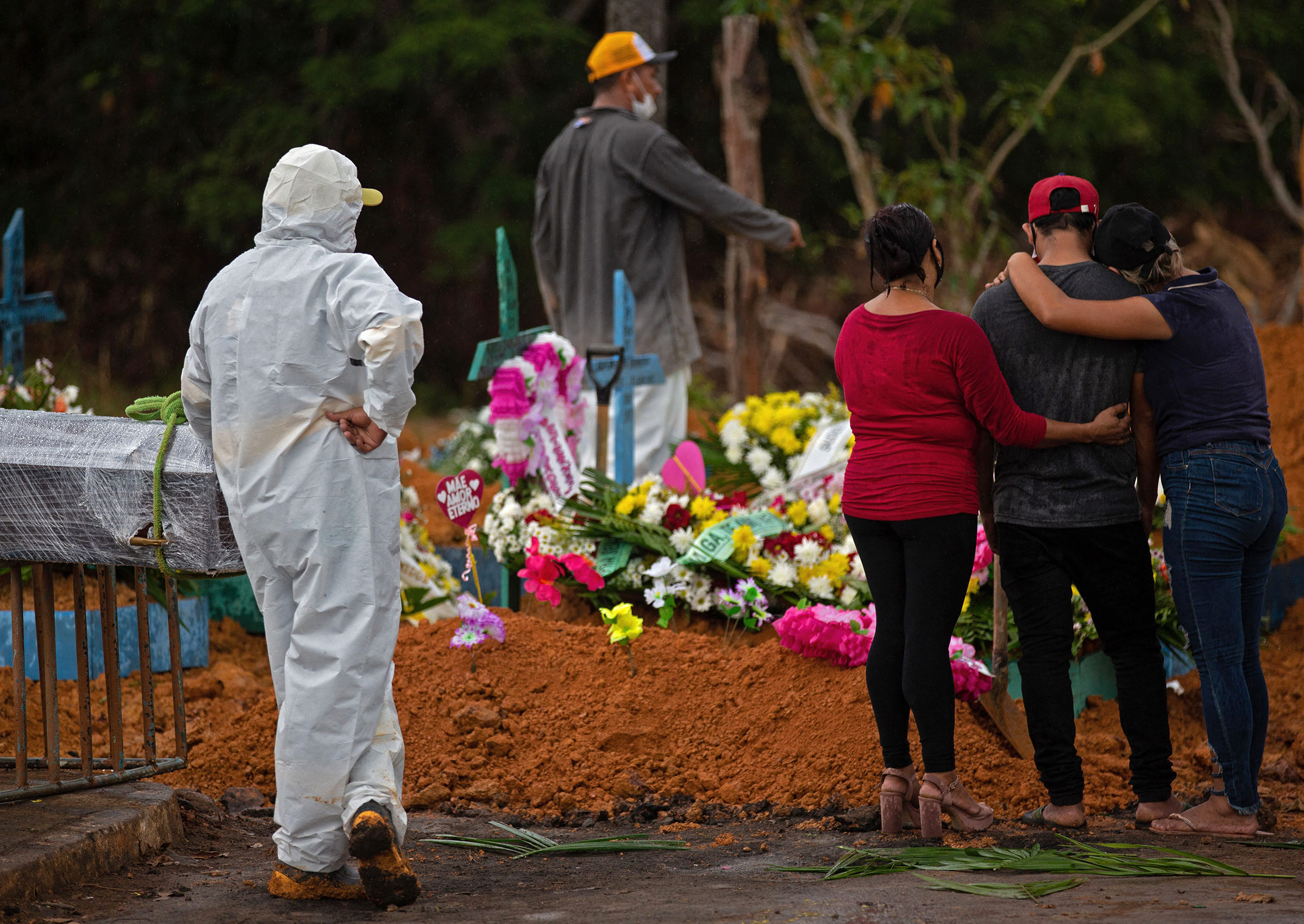 Relatives attend the burial of a Covid-19 victim at Nossa Senhora Aparecida cemetery in Manaus, Brazil on April 15. 