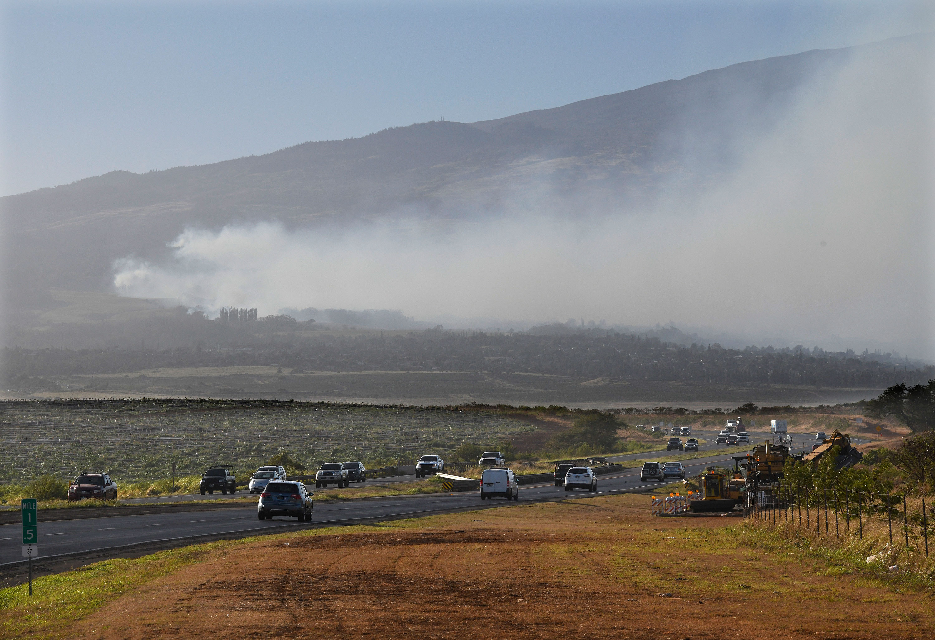 Smoke blows across the slope of Haleakala volcano on Maui, Hawaii, as a fire burns in Maui's upcountry region on August 8.