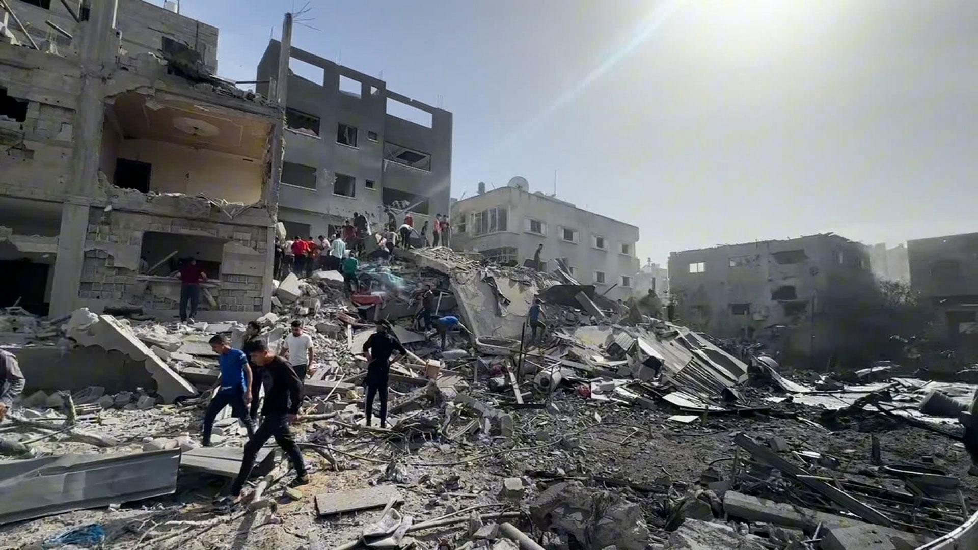 Palestinians look at the destruction after an Israeli airstrike in northern Gaza's Al-Nazla neighborhood in Jabalya on Sunday. 