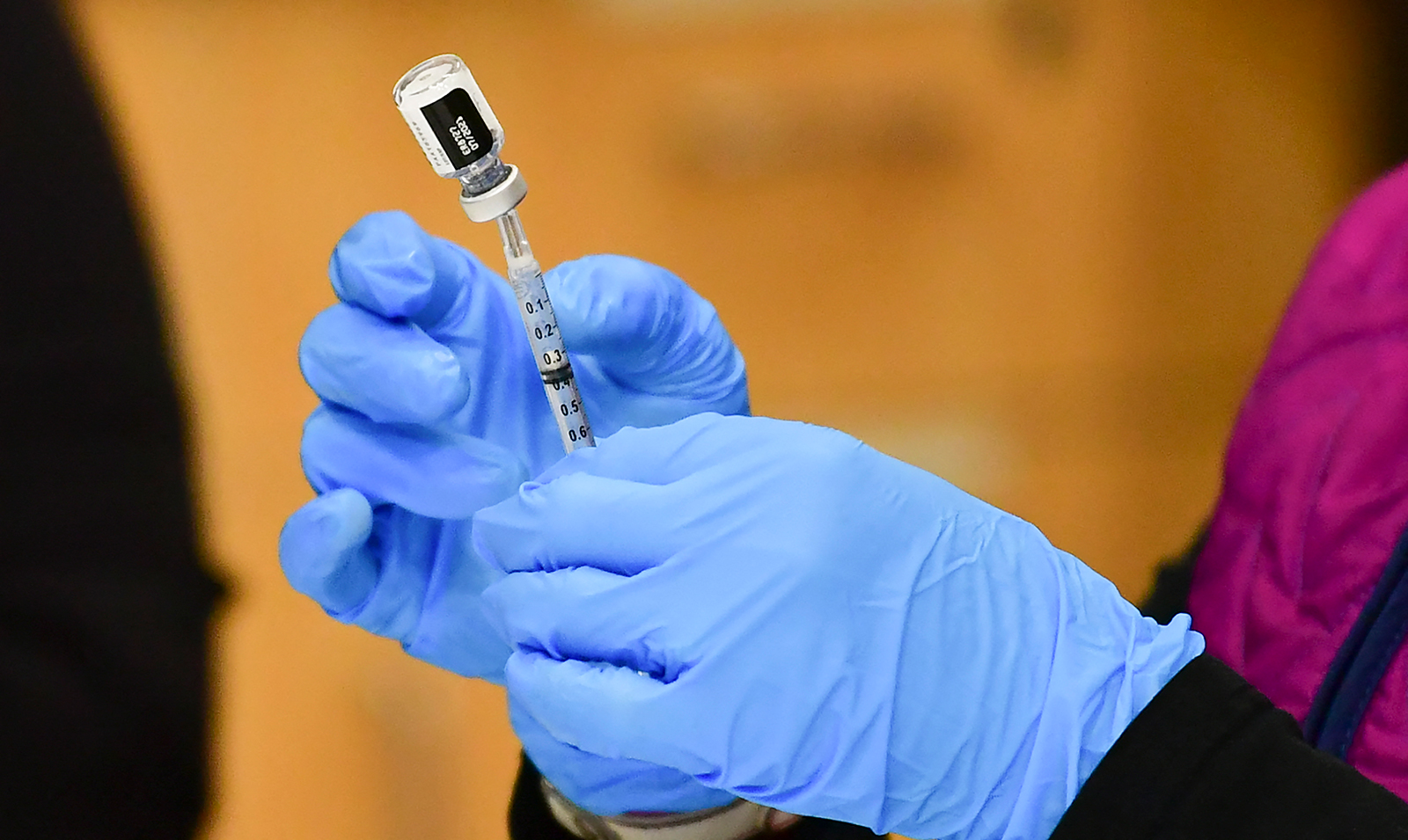 A nurse loads a syringe with a dose of the Pfizer Covid-19 vaccine at the Blood Bank of Alaska in Anchorage, on March 19