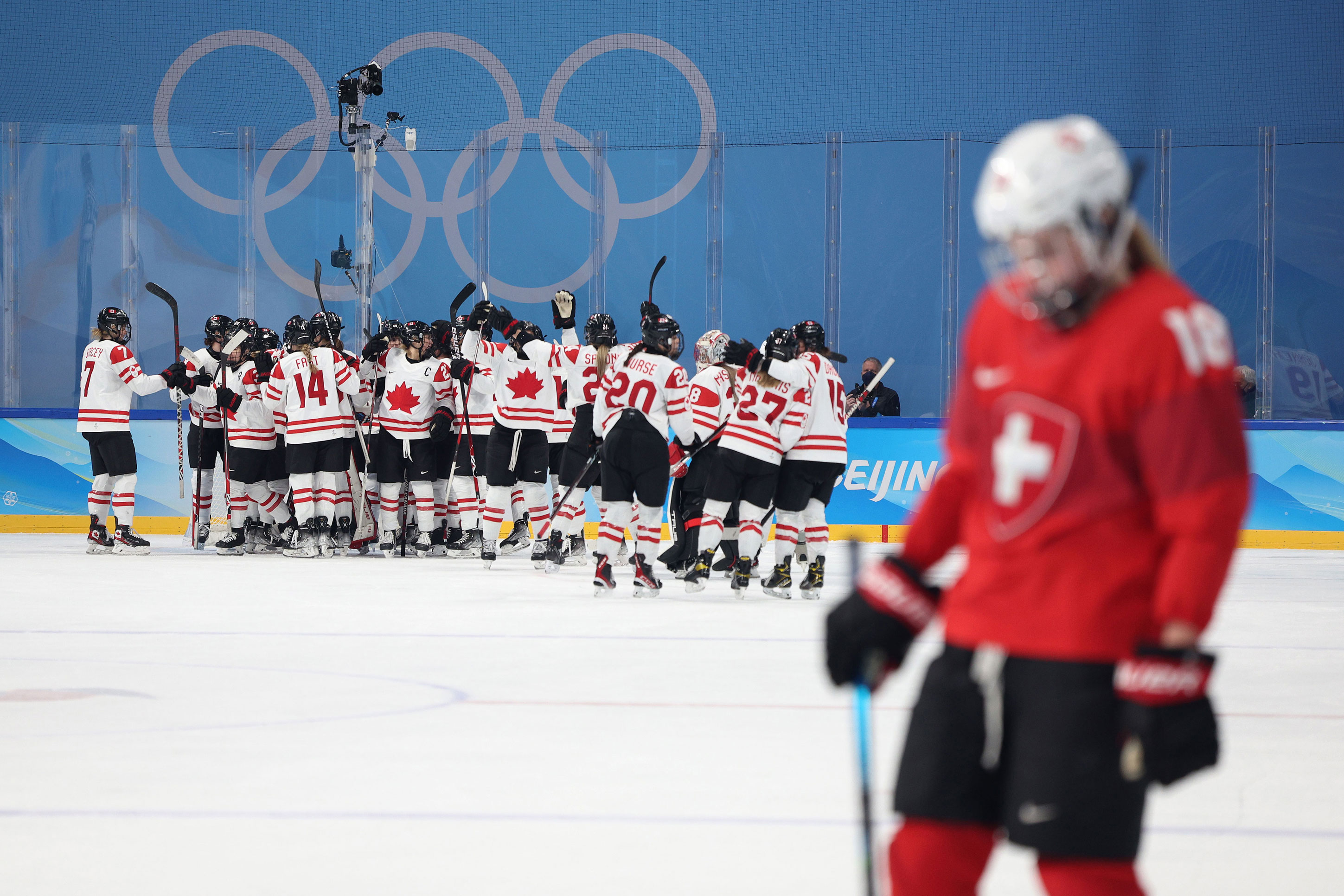 Team Canada celebrate after their 10-3 win against Switzerland in the women's ice hockey semifinals on Monday.
