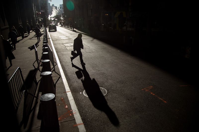 Pedestrians walk along Wall Street in New York, on Wednesday, Nov. 9.