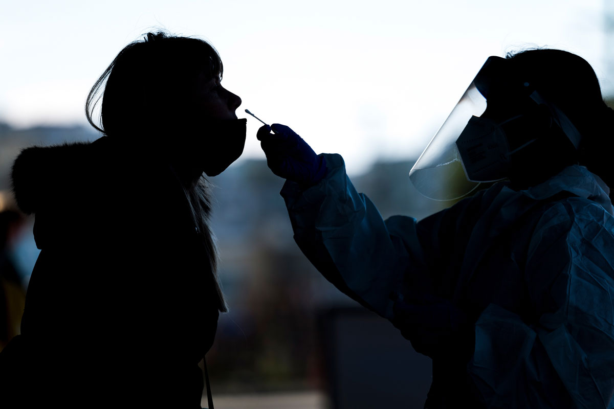 A medical worker wearing personal protective equipment administers a Covid-19 test at the Alemany Farmers Market in San Francisco, California, on November 19.