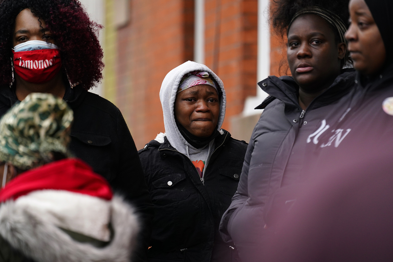 People near the scene of a deadly row house fire on Wednesday.