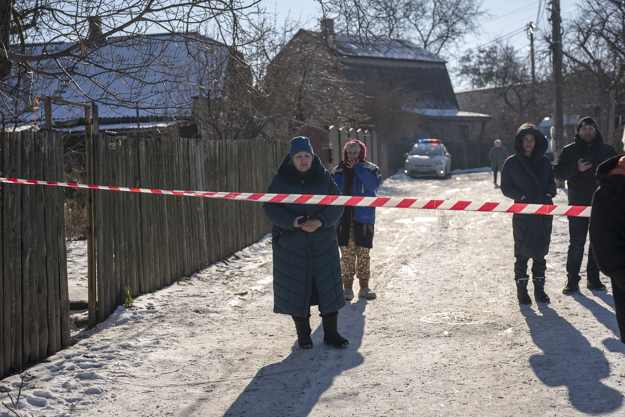 Residents wait behind police cordon to return to their homes after a rocket attack in Kyiv, Ukraine, on February 10.