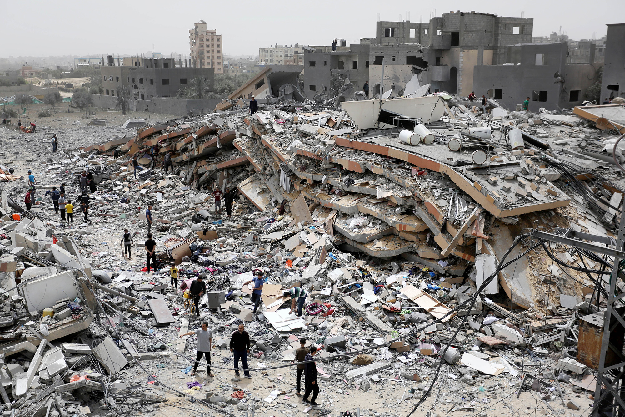 Palestinians living in Nuseirat Refugee Camp collect the usable items among the rubble of the destroyed buildings after Israel withdrawal from northern Nuseirat Camp in Deir Al Balah, Gaza, on April 18.