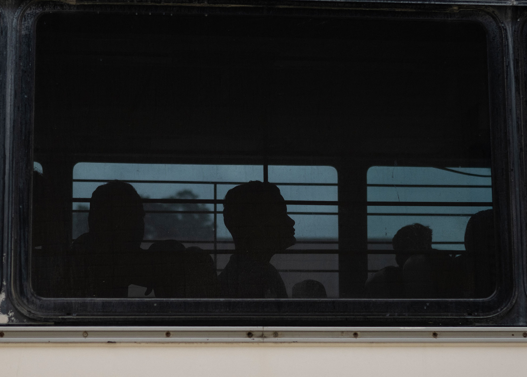 A migrant looks on as he waits to get off a bus at a processing center on May 11 in Brownsville, Texas. 