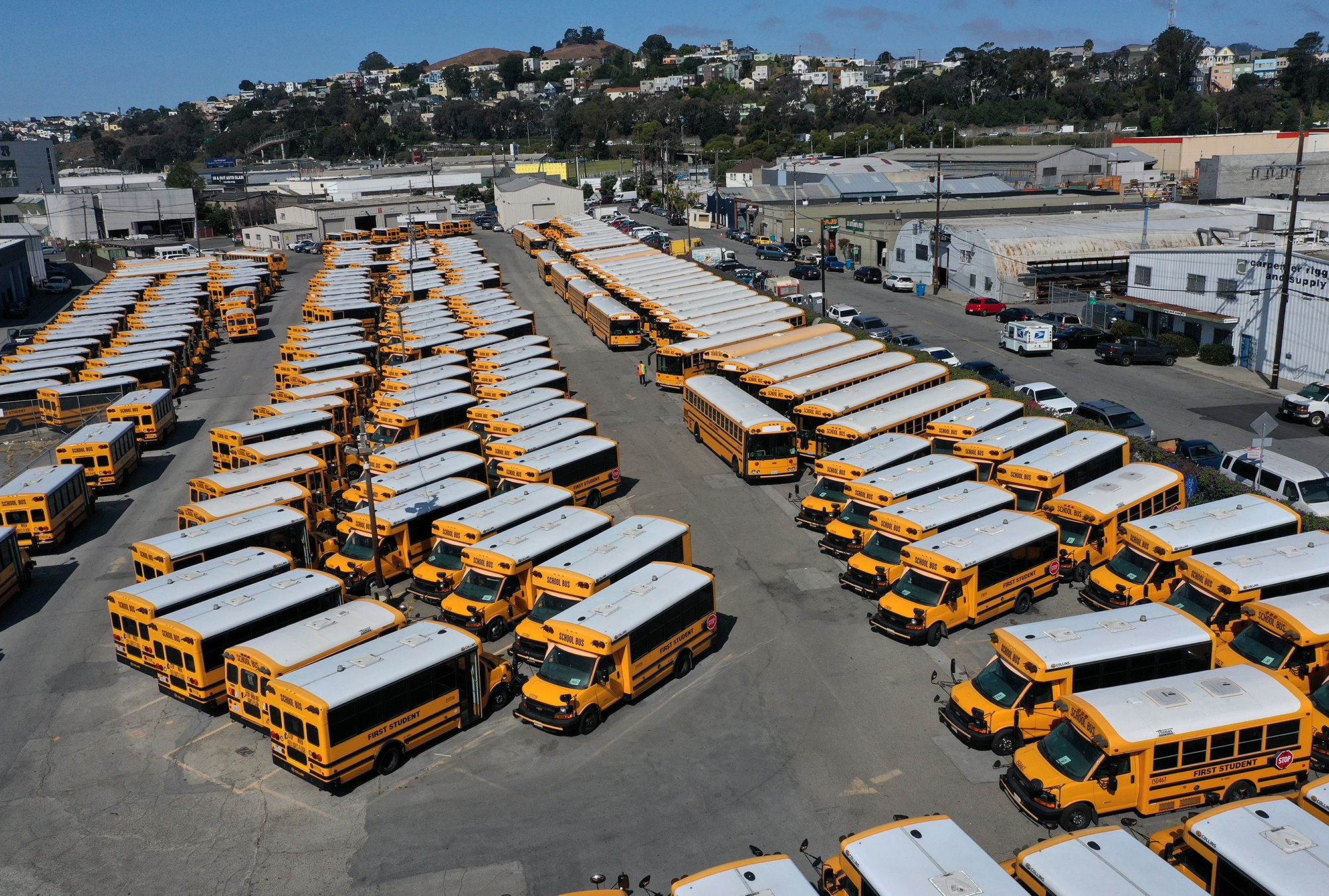 School buses sit parked in a lot at First Student Charter Bus Rental on July 14, 2020 in San Francisco, California. 