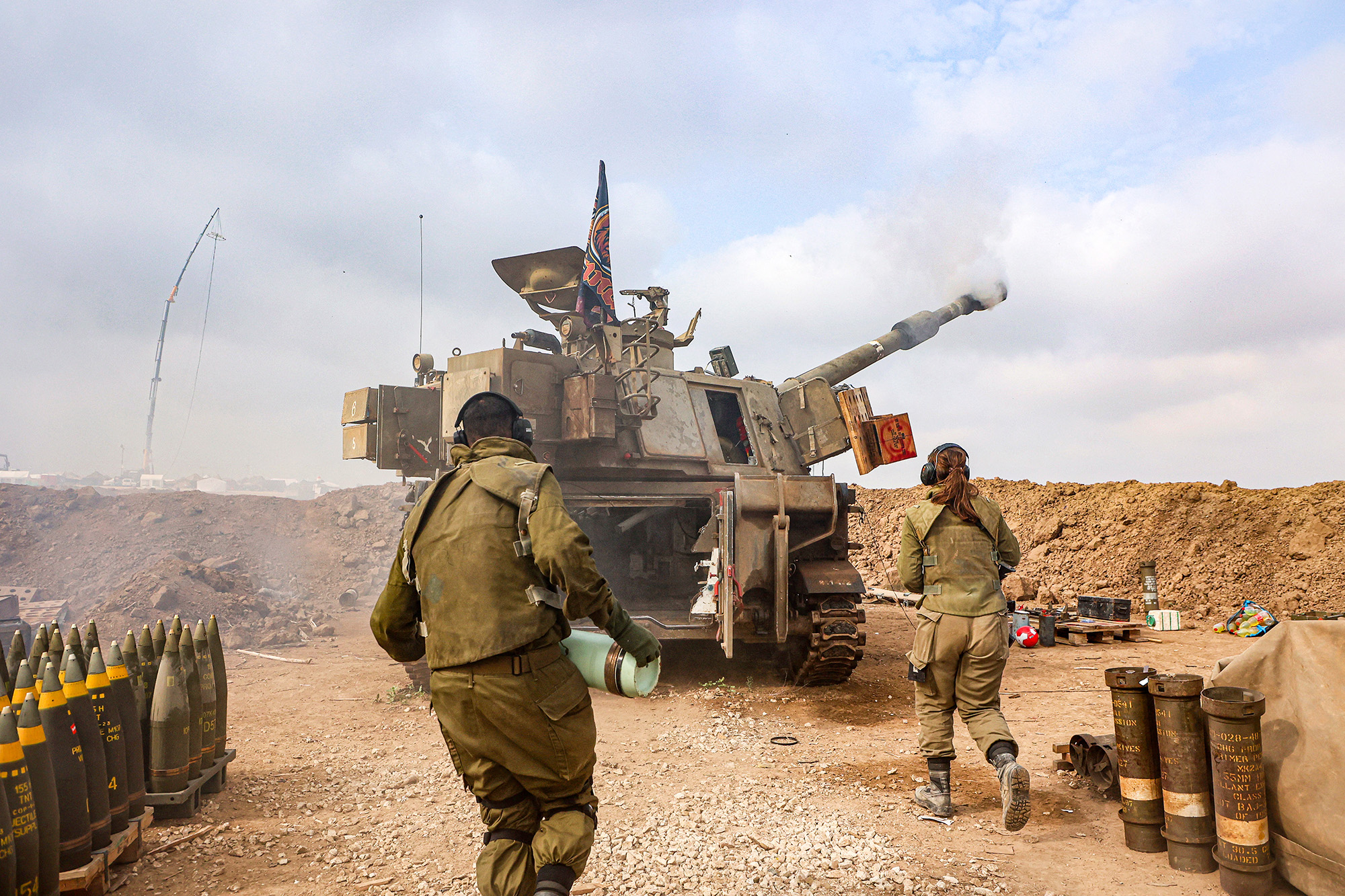 An Israeli artillery unit is pictured firing near the border with Gaza on December 5.