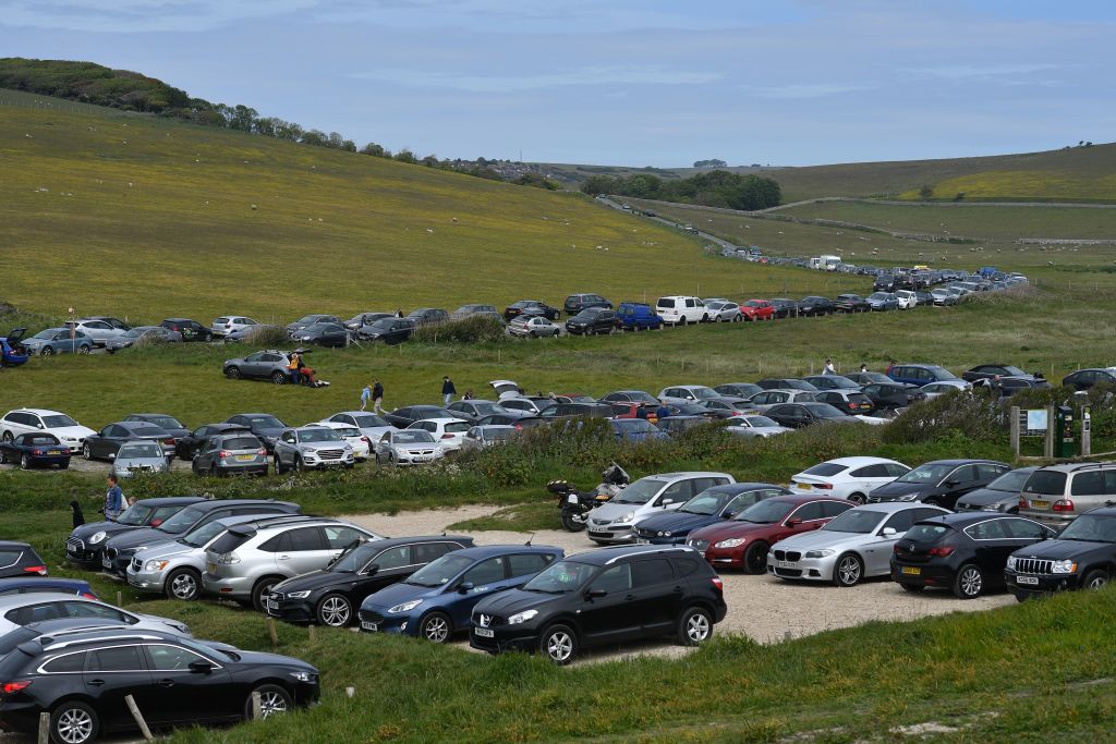 Cars are seen parked in the car parks and along the road-side at Birling Gap near Beachy Head on the south coast of England on May 17.