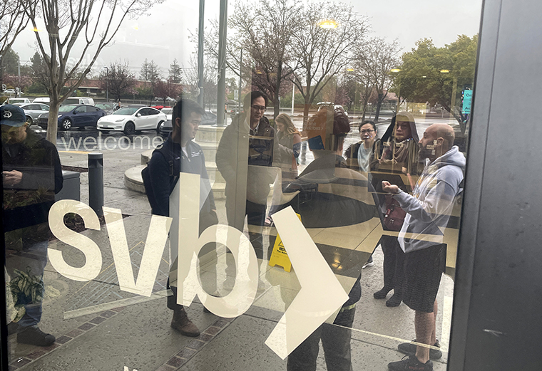 People line up outside of the shuttered Silicon Valley Bank (SVB) headquarters today in Santa Clara, California. 