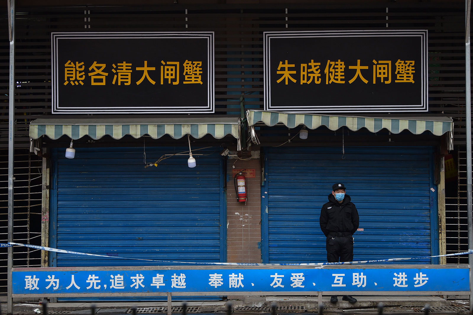 A security guard stands outside the Huanan Seafood Wholesale Market in Wuhan, China, on January 24.