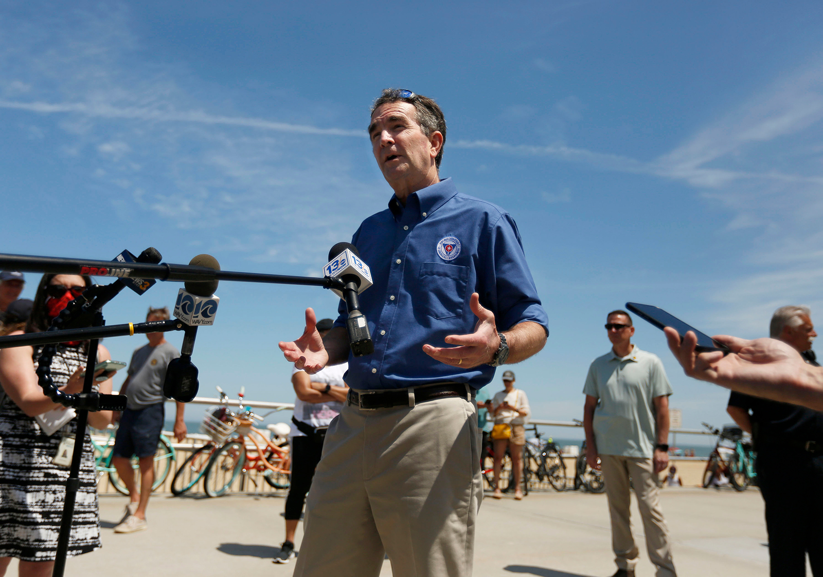 Gov. Ralph Northam talks to the media during a brief visit to Virginia Beach, Virginia, on May 23.