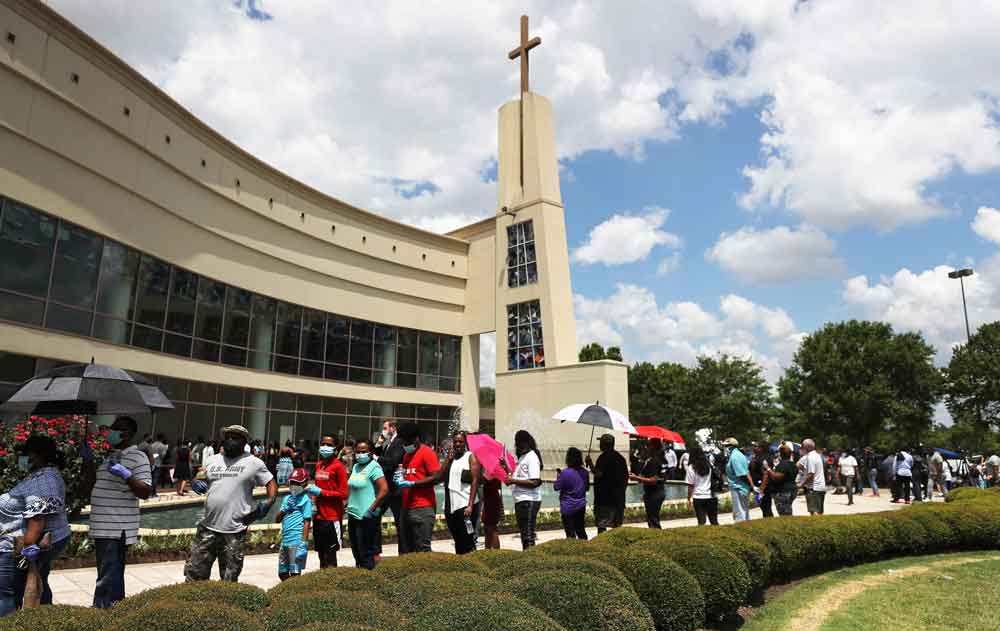 People wait to attend the public memorial for George Floyd outside of the Fountain of Praise church on Monday in Houston, Texas.