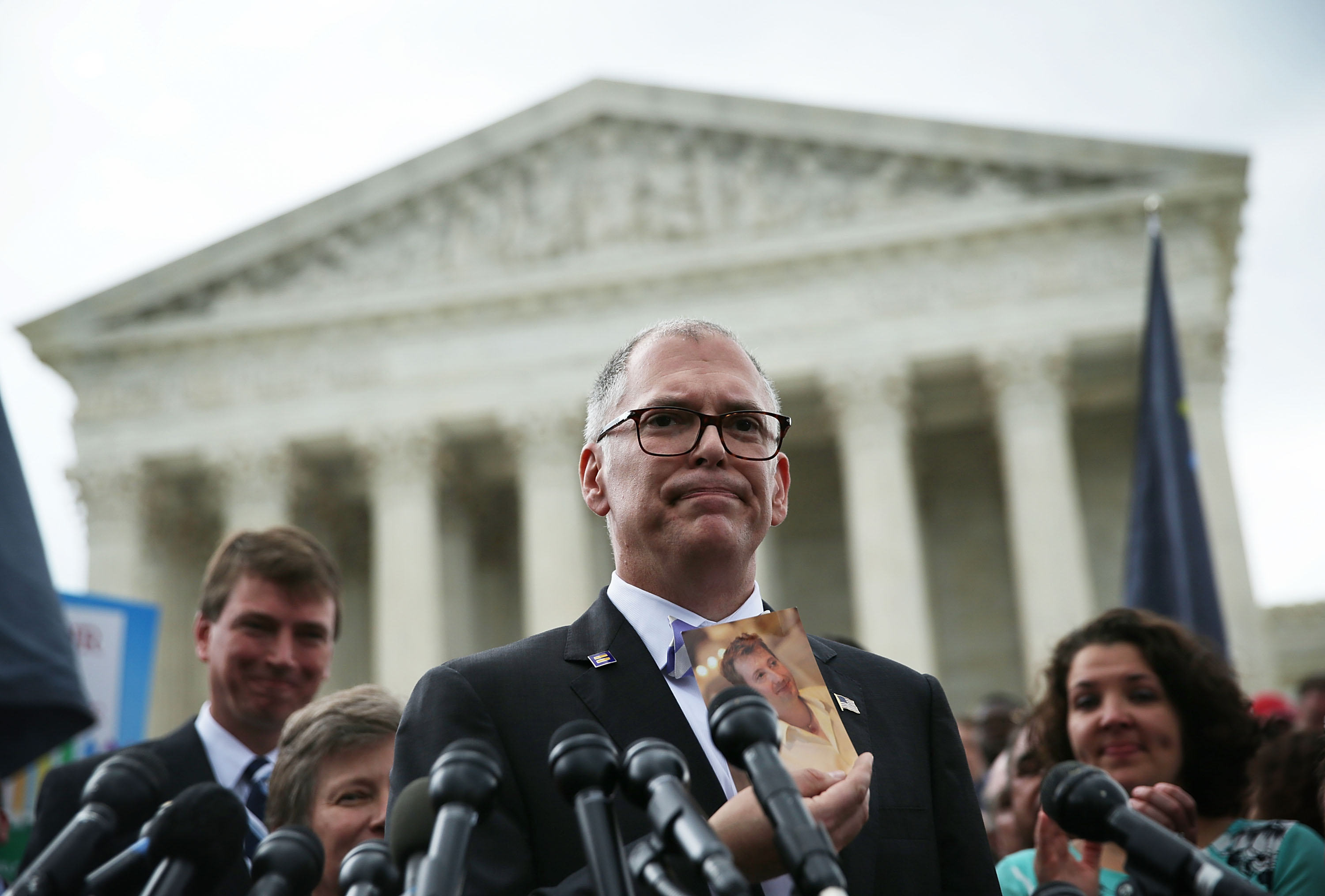 Jim Obergefell holds a photo of his late husband John Arthur as he speaks to members of the media in June 2015 outside the US Supreme Court after gay marriage was legalized.